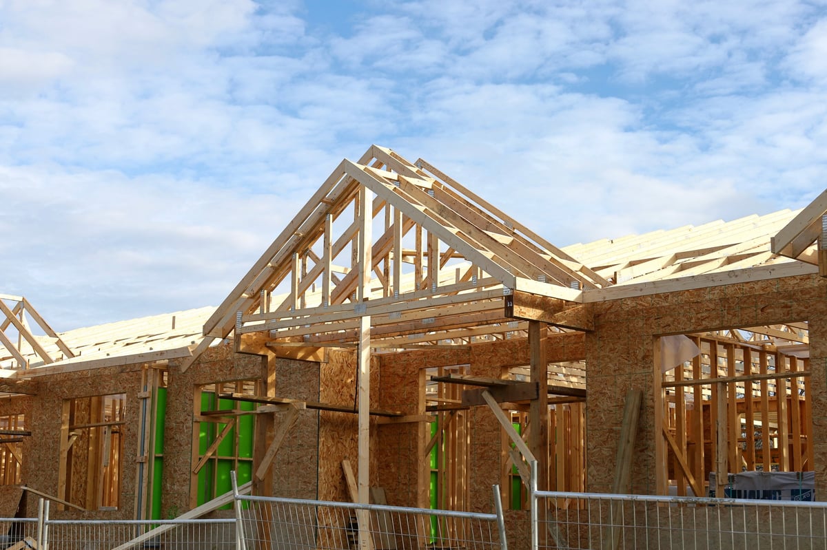 New residential building framed with wood showing construction process